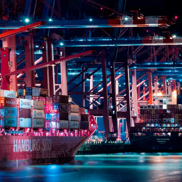 Night time shot of container ships and cranes in Port of Hamburg.